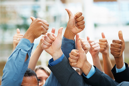 Photo of many office workers with thumbs up in the air